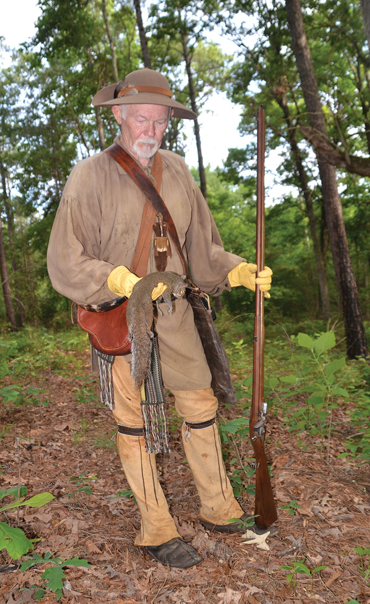 Kinton shows off the first squirrel he took on that morning when he was making meat for a stew.